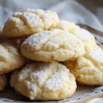 Soft and buttery Lemon Pound Cake Cookies dusted with powdered sugar, served on an elegant plate.