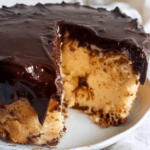 Close-up of a sliced Boston Cream Poke Cake with moist vanilla sponge, creamy pudding filling, and rich chocolate glaze on a white plate