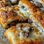 Golden, crispy Lovely Philly Cheesesteak Stuffed Cheesy Breadsticks oozing with melty cheese and seasoned beef, topped with a buttery crust.