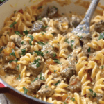 A pot of one-pot creamy beef and garlic butter pasta with tender beef, rotini pasta, and a rich, creamy sauce, garnished with fresh parsley.