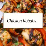 Juicy grilled chicken kebabs with bell peppers, garnished with fresh herbs, served on skewers on a white plate.