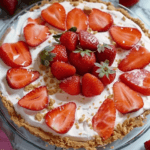 A No-Bake Strawberry Speculoos Pie with a creamy filling, a crunchy Speculoos cookie crust, and fresh sliced strawberries on top.