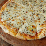 Sliced cheesy garlic tortilla bread topped with melted mozzarella and herbs on a wooden serving board.