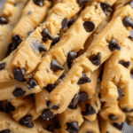 Close-up of raw cookie dough twists studded with semi-sweet chocolate chips.